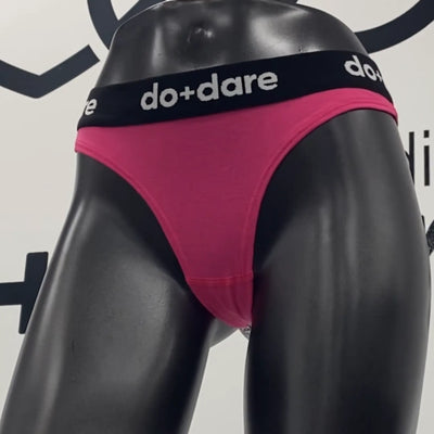 Pink underwear with a black waistband featuring 'do+dare' logo on a mannequin against a white background.
